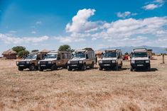 four vehicles are parked in the middle of a field