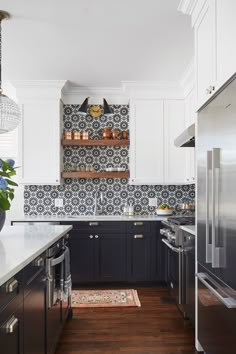 a kitchen with black cabinets and white counter tops