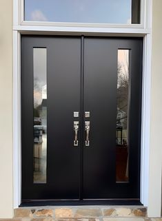 a black double door with two sidelights