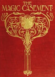 an old book with gold lettering on the cover, and a golden bird sitting on top of it