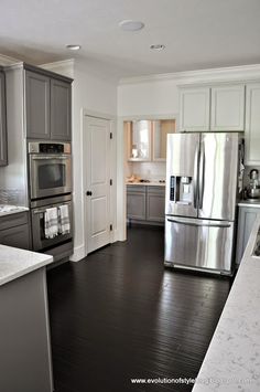 a kitchen with stainless steel appliances and wood floors