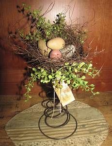 a bird's nest filled with eggs and greenery on a round table mat