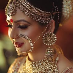 a woman with makeup and jewelry on her face