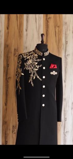 a black coat with gold and red details on it