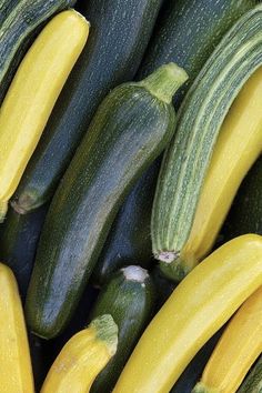 several zucchini's and squash are stacked up close together in this image