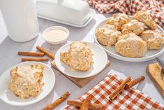 the table is covered with plates of biscuits and cinnamon sticks