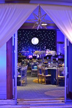 an open door leading into a banquet hall with tables and chairs set up for a formal function