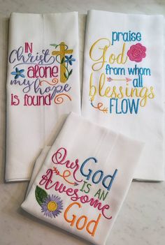 three embroidered napkins with words on them