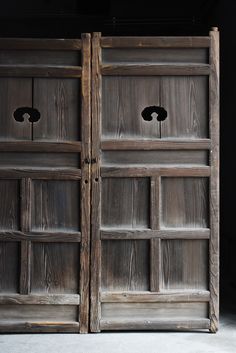 two wooden doors with black knobs on them