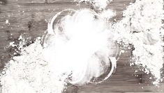 a pile of white powder sitting on top of a wooden table