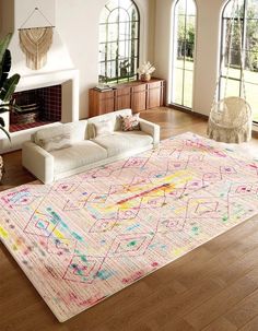 a living room filled with furniture and a large rug