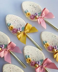 several decorated spoons with bows and flowers on them