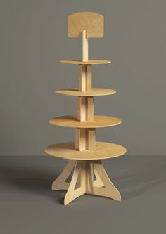 a three tiered wooden display stand with a candle in the middle and two shelves on each side