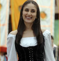 a woman in a black and white dress smiling