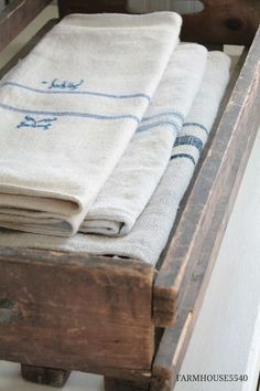 three towels are stacked on top of each other in an old wooden crate with drawers