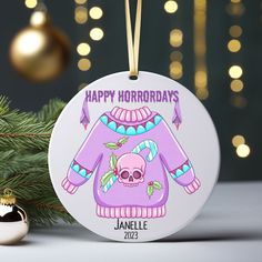 an ornament with a sweater and skull on it next to a christmas tree