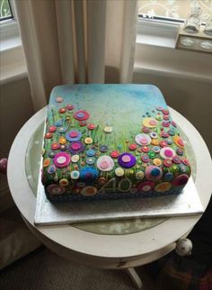 a cake decorated with flowers on top of a table