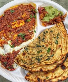 a paper plate topped with different types of food