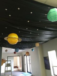 the ceiling in an office has planets and stars on it