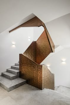 a stair case made out of copper foil on the side of a wall next to some stairs