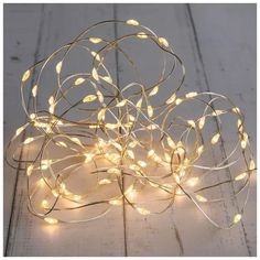 a bunch of lights that are on top of a wooden table with white wood flooring