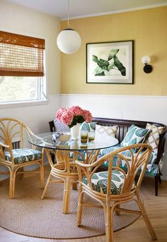 a glass table with four chairs around it