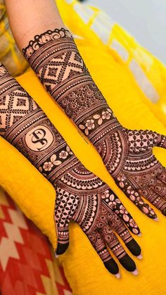 two hands with henna designs on them