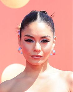 a close up of a person wearing large earrings