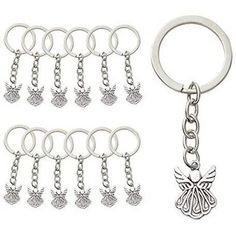 six key chains with charms attached to them and an angel charm hanging from the bottom