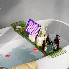 a bathtub with soaps, lotion and other items in it