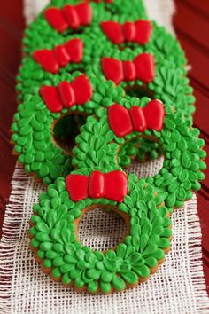 green and red decorated cookies sitting on top of a table