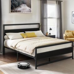 a bed room with a neatly made bed next to a chair and a painting on the wall