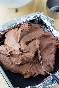 there is a chocolate frosted cake in the pan