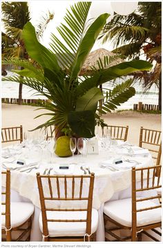 the table is set with white linens and place settings