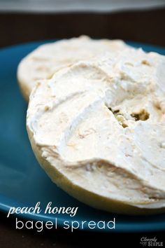 a blue plate topped with a bagel covered in cream cheese