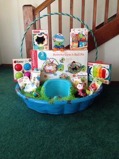 a basket filled with toys sitting on top of a green carpet