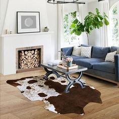 a living room filled with furniture and a fire place next to a window covered in plants