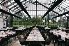 an indoor dining area with tables and chairs set up for a formal dinner or party