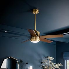 a ceiling fan is hanging from the ceiling in a room with blue walls and furniture