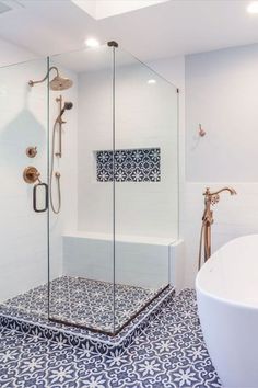 a bath room with a stand up shower and a white tub sitting next to it