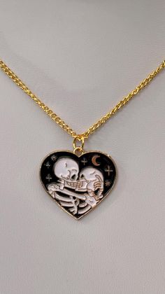 Skeleton Lovers in a heart shaped pendant with gold accents.  Crescent moon and stars also on this striking pendant.   Gold plated chain is approximately 18 inches long with lobster claw clasp.  If you would like a longer or shorter chain, please message me. Skeleton Lovers, Skeleton Love, Skeleton Necklace, Stationary Supplies, Heart Shaped Pendant, Cute Stationary, Love Jewelry, Heart Shape Pendant, Moon And Stars