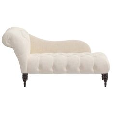 an upholstered chaise lounger with buttons on the back and legs, in white