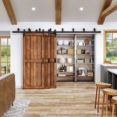 a large open kitchen with sliding doors and wooden flooring in the middle of it