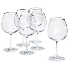 six wine glasses are lined up in a row