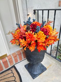 a vase filled with lots of colorful flowers on top of a door way sill