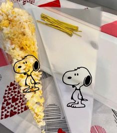 a bag filled with popcorn and peanuts on top of it