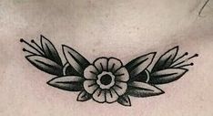 a woman's chest with a flower tattoo on it