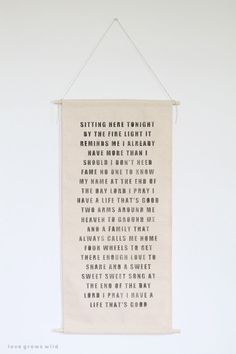 a white wall hanging with a poem on it