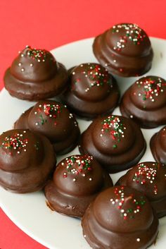 chocolate covered donuts with sprinkles on a plate