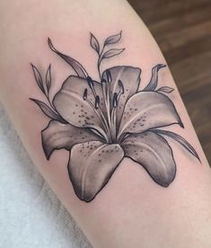 a black and white flower tattoo on the arm